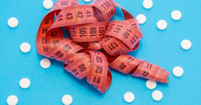 Measuring tape and metformin pills