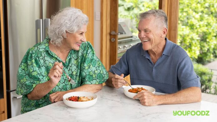 Couple chat over food.