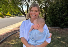 Caitlin asks for life-saving diabetes technology to be unlocked for those who need it most Caitlin Rogers holds baby Mac with trees in the background.